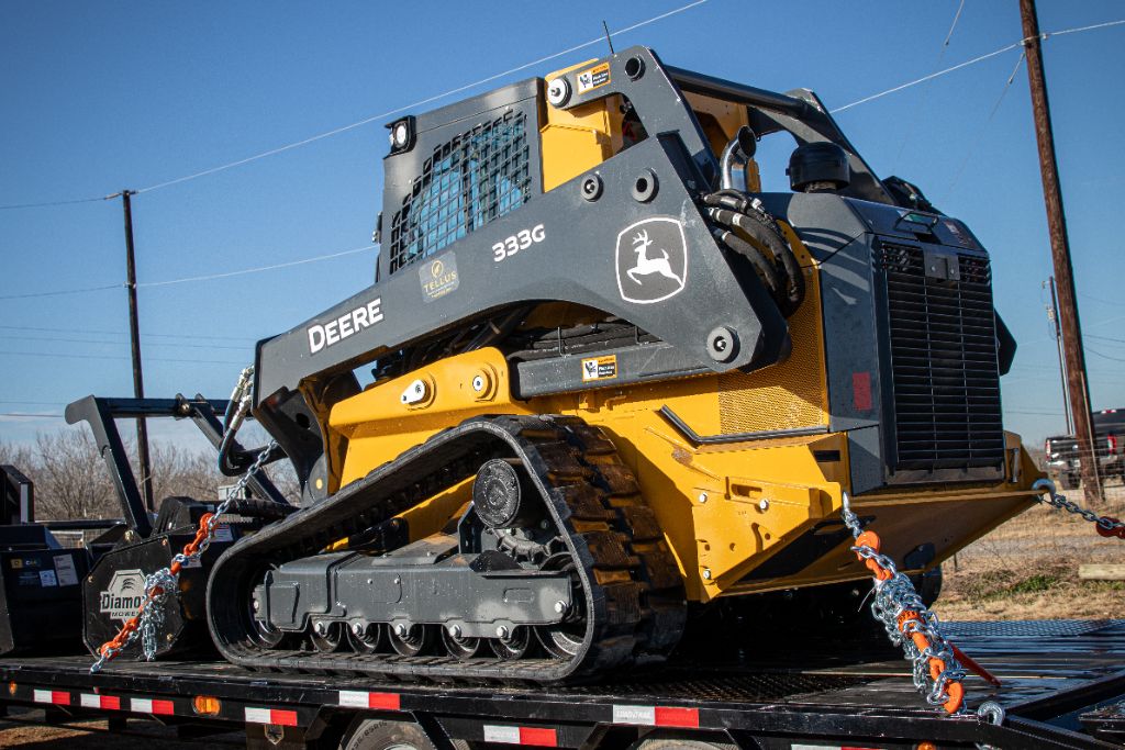 John Deere 333G tracked skid steer on trailer
